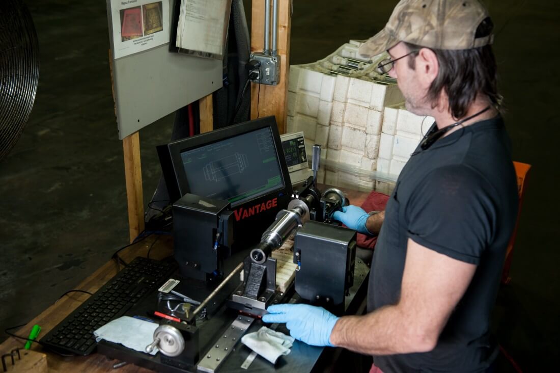 Employee polishing piece of metal